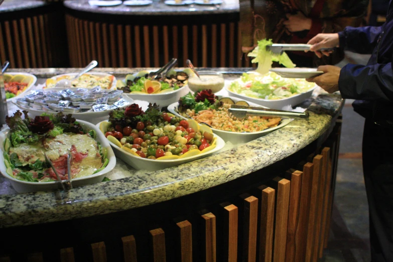 a restaurant buffet table is served with various foods