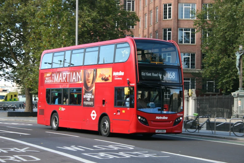 a large red bus that is next to a parking meter