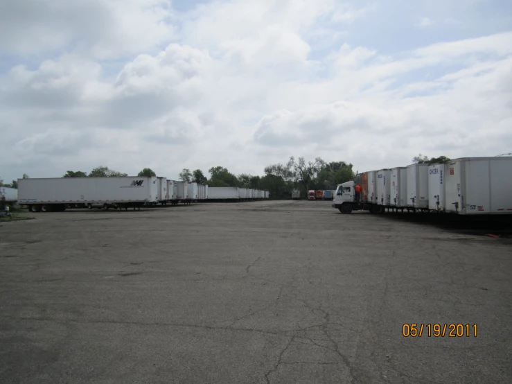 a couple large trucks parked in an empty lot