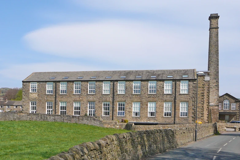 a large brick building sitting in the middle of a field