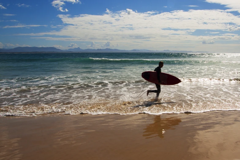 a person holding a surf board in the water