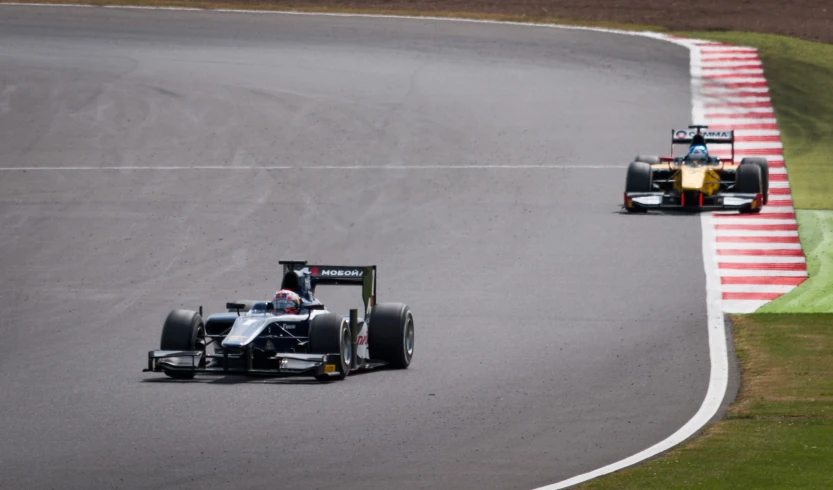 two cars that are racing in a race