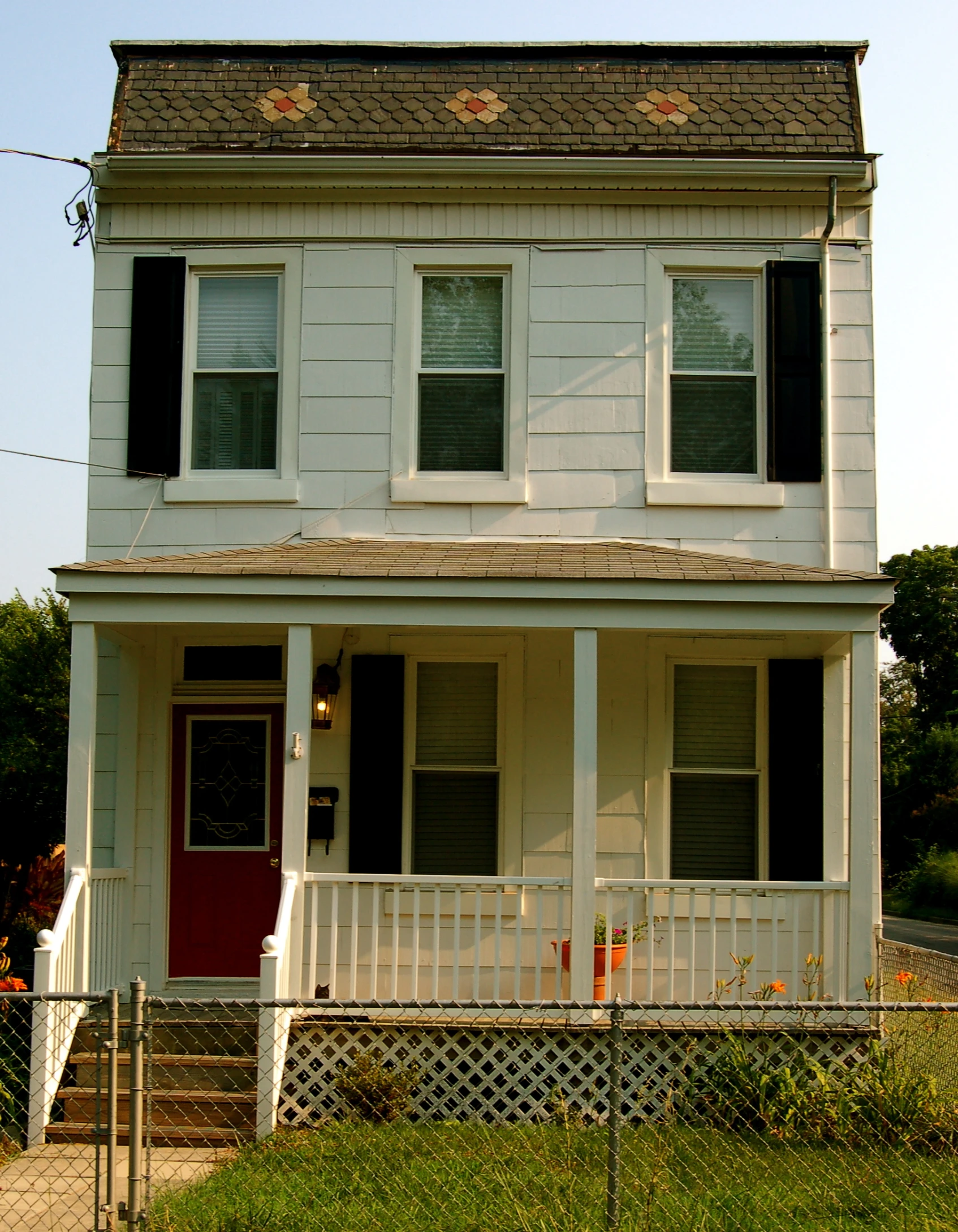 the house has a red door and white trim on it