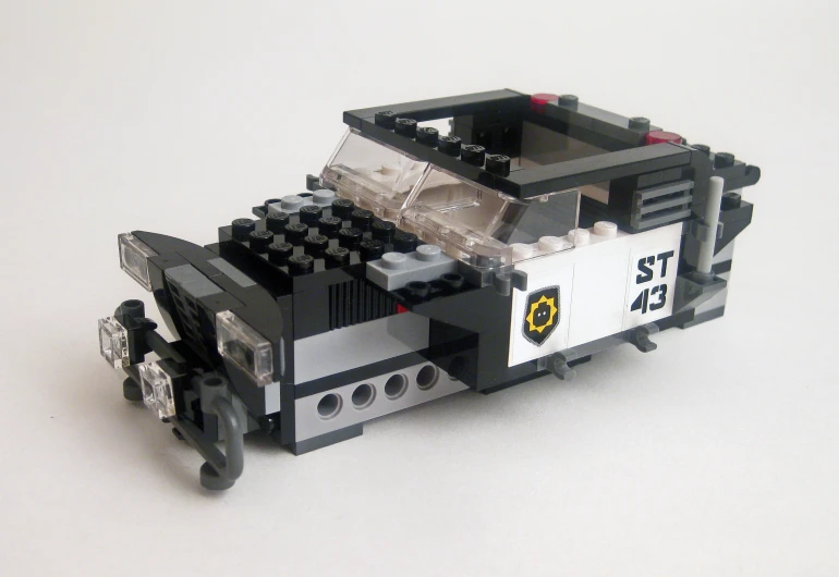 lego toy with a mini police car sitting on a table