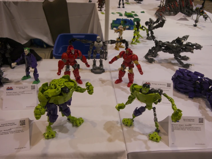 plastic toys and action figures for sale on a table