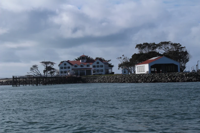 an island with a boat dock and two houses on it