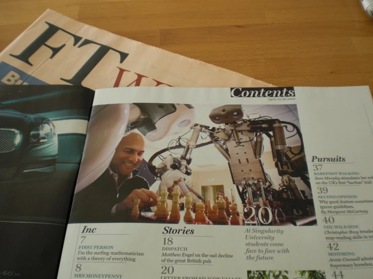 a table topped with magazines and a cellphone