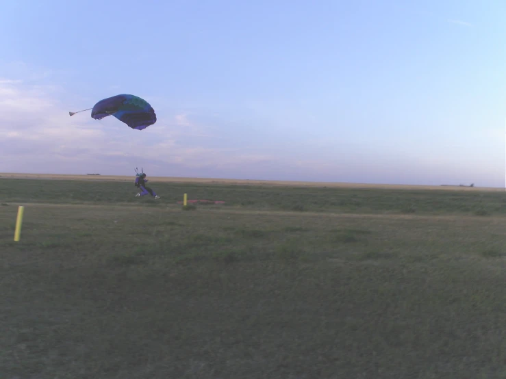 a man on a field with a parachute
