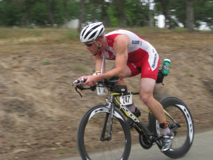 a man on a bike riding down a road