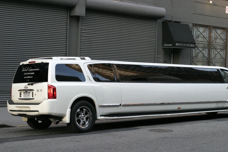 a limousine is parked on the side of a city street