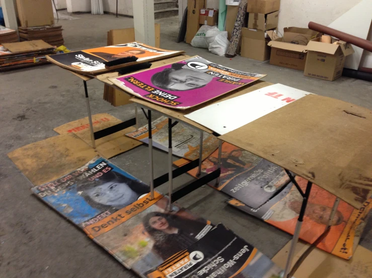 several papers sit on top of folding tables in a warehouse