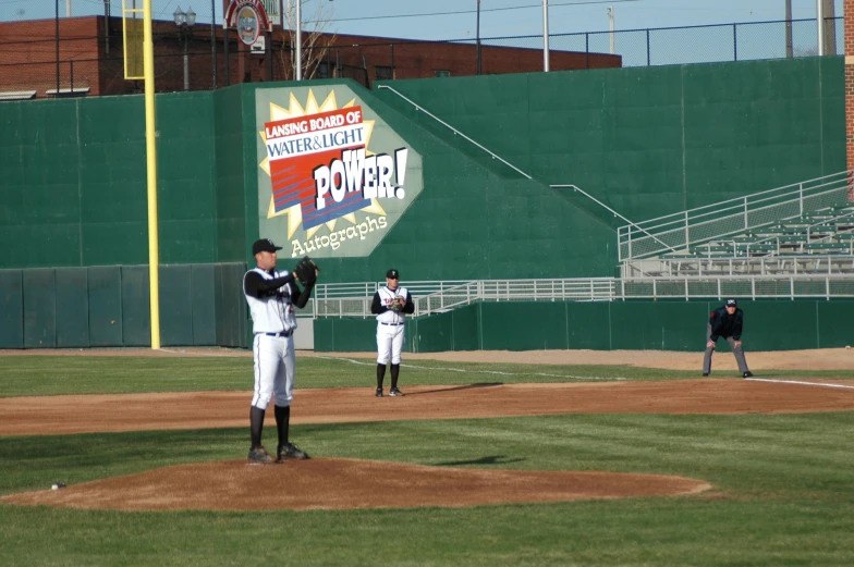 some baseball players are playing baseball on the field