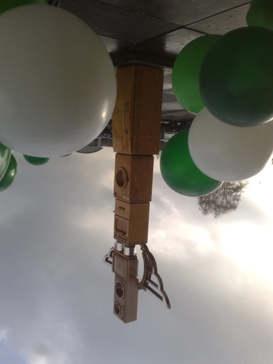 some white, green and black balloons in the air