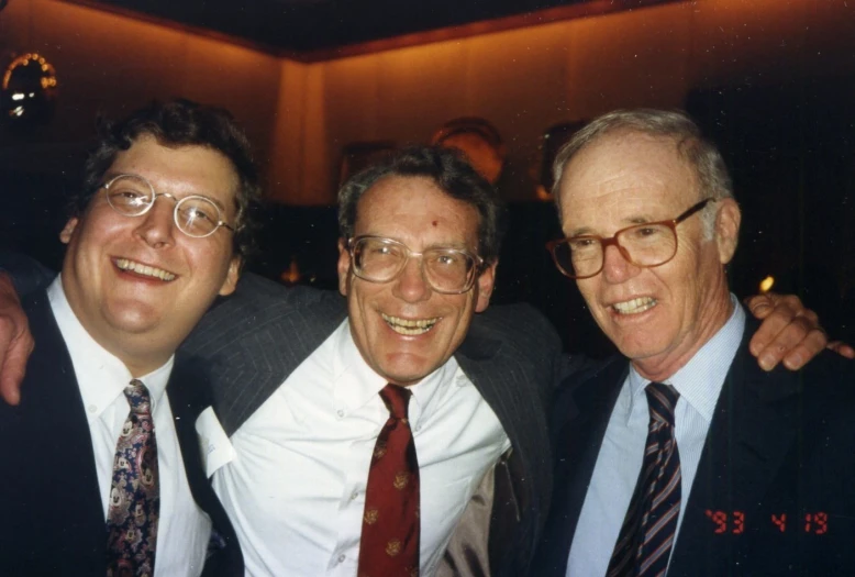 three men posing for a po in suits and ties