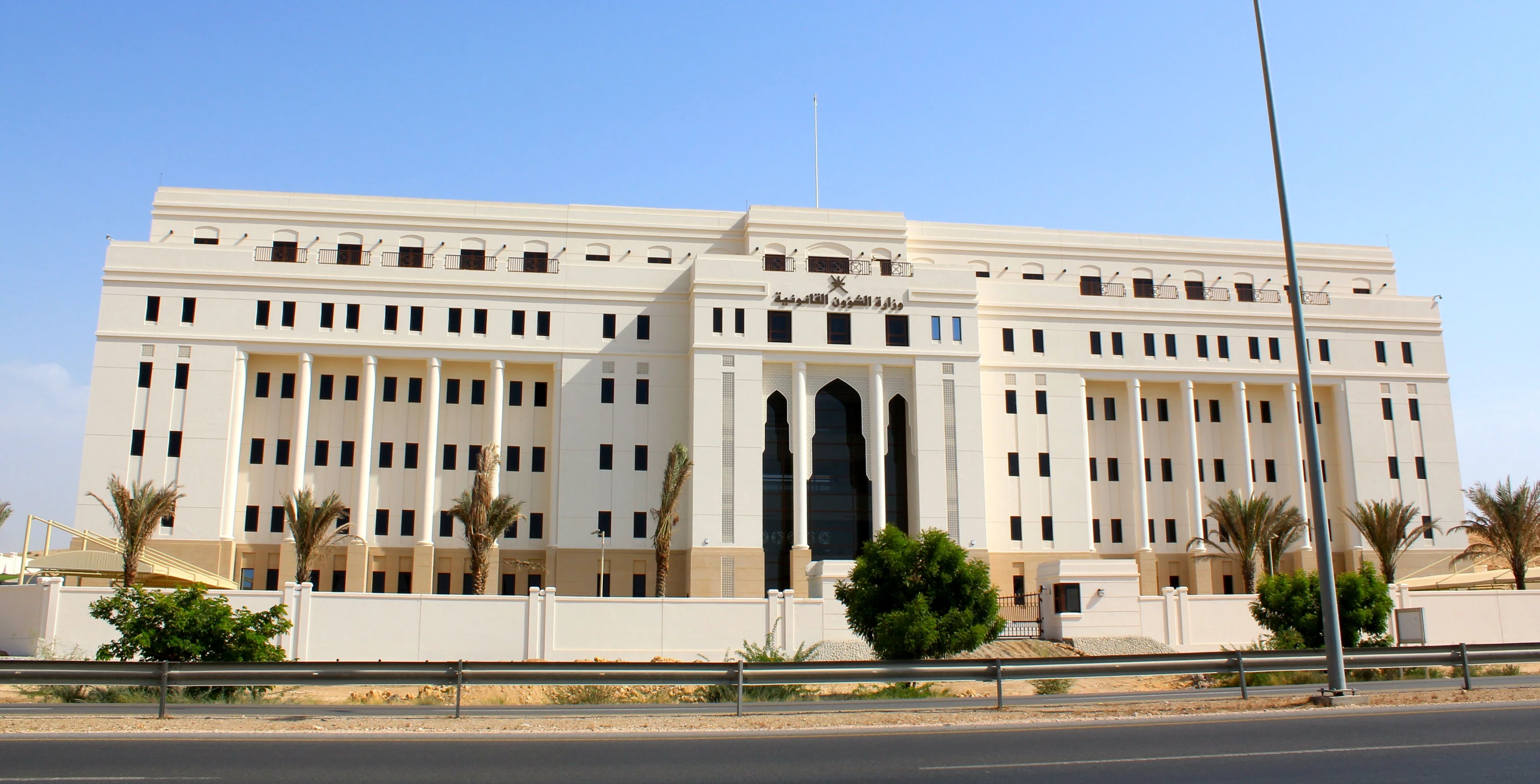 an old white building on a street corner