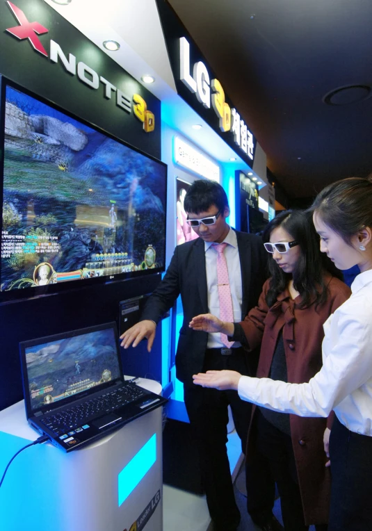 people watching an exhibit with an old fashioned computer