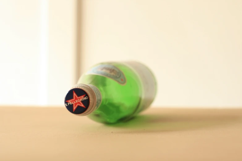 a green bottle that has a red star on it