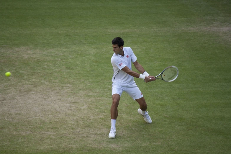 a male tennis player returning the ball to his opponent