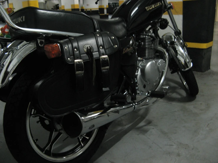 a motorcycle parked inside of a garage in front of a wall