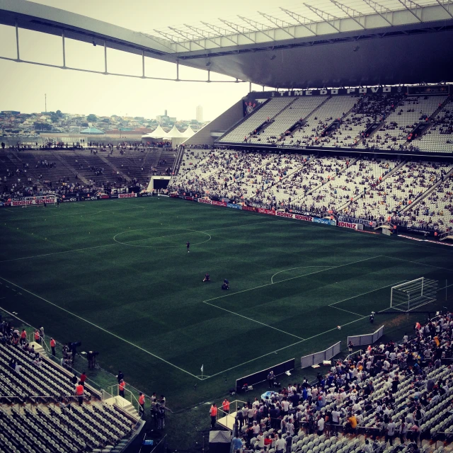 an empty soccer stadium filled with fans watching and playing