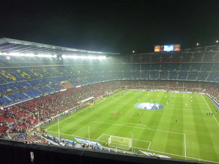 a crowd at a stadium is looking out on the field