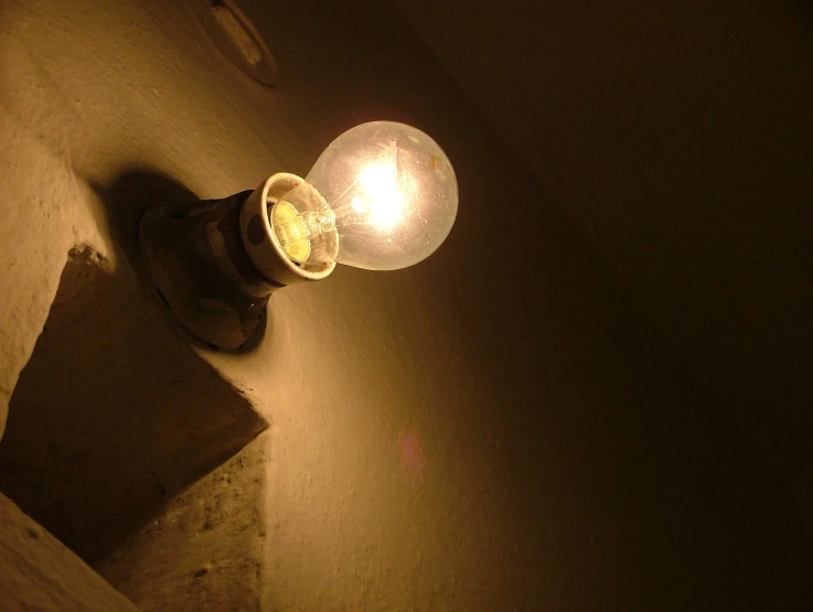 a light sitting on the side of a building