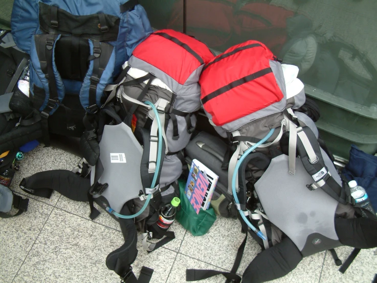 a group of backpacks stacked on top of each other
