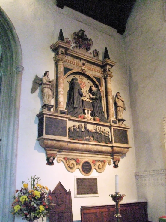 an ornate religious building with statues above it