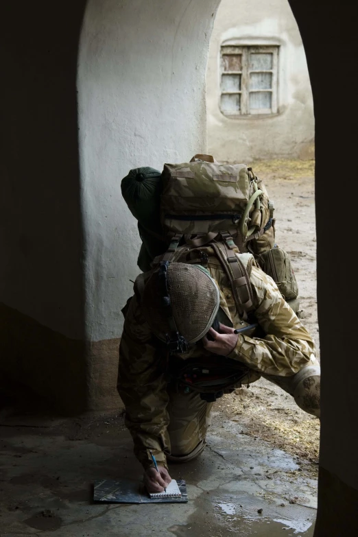 a man is crouched down looking at a phone