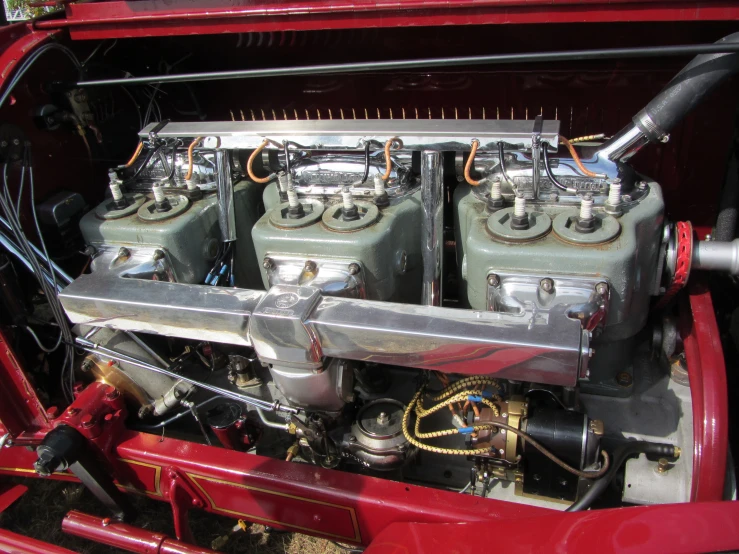the front engine of a red classic car
