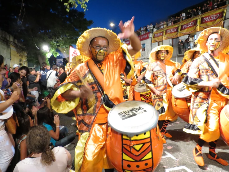 a group of people with faces painted like orange