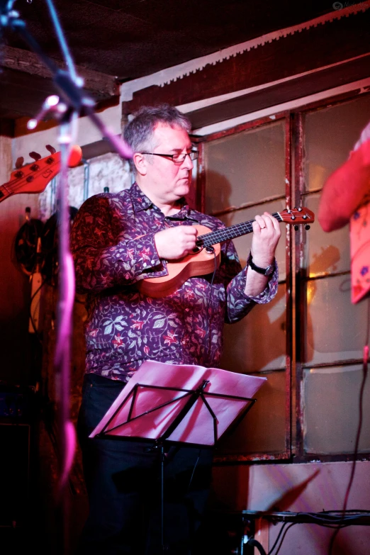 a man is playing his guitar on the stage