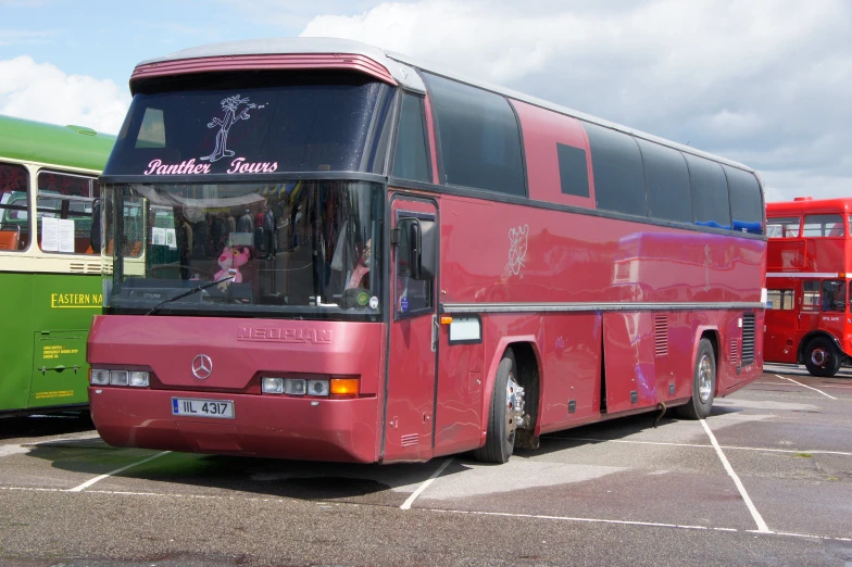 two double decker buses parked in a lot