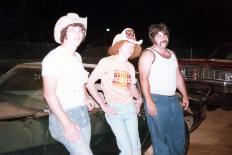 a few men wearing hats and standing next to each other