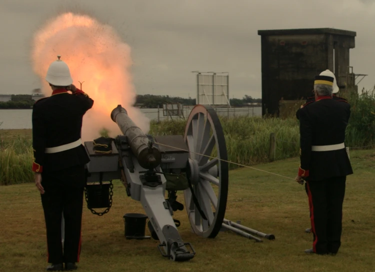 two men in uniform hold a fire cannon