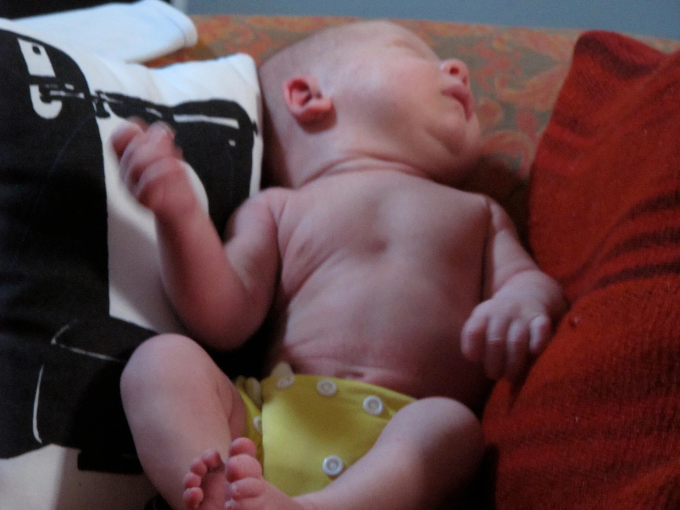 a baby in a diaper is laying on a bed