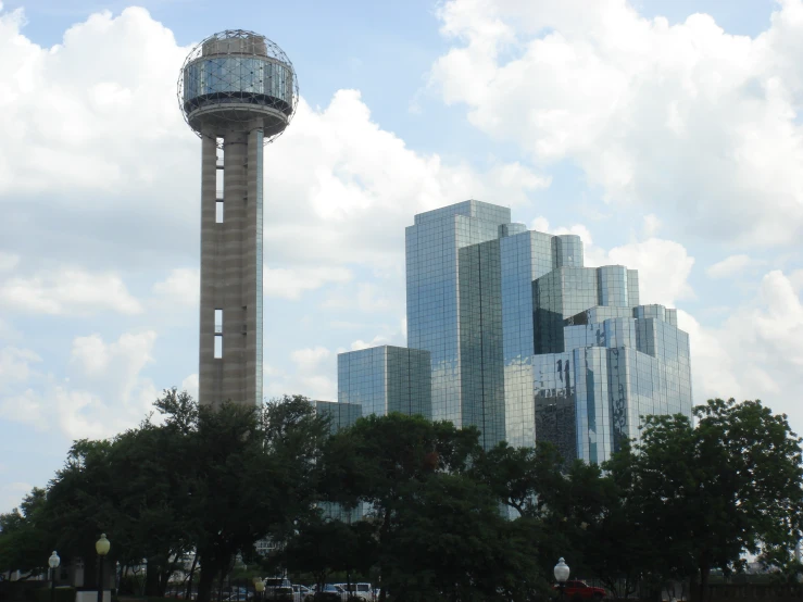 a water tower surrounded by buildings against a blue sky