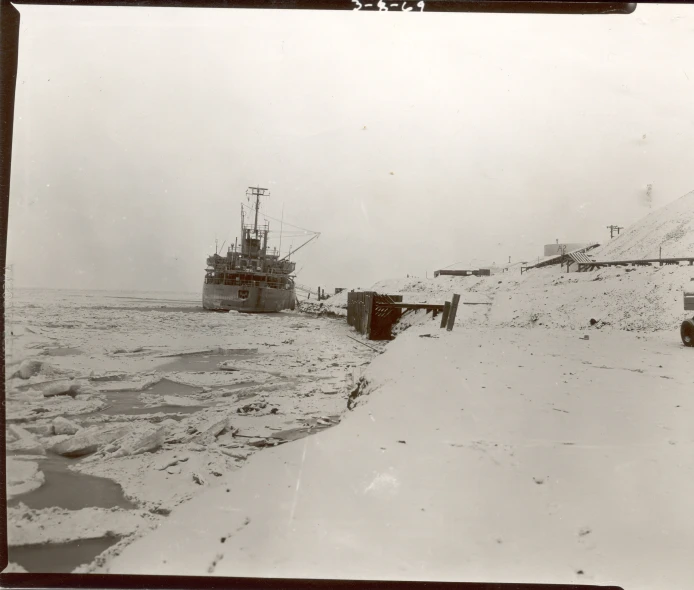 old po of snow covered beach with cars in background