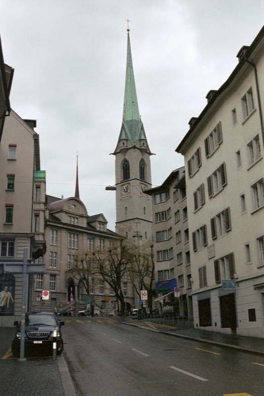 a street corner with many buildings next to a church