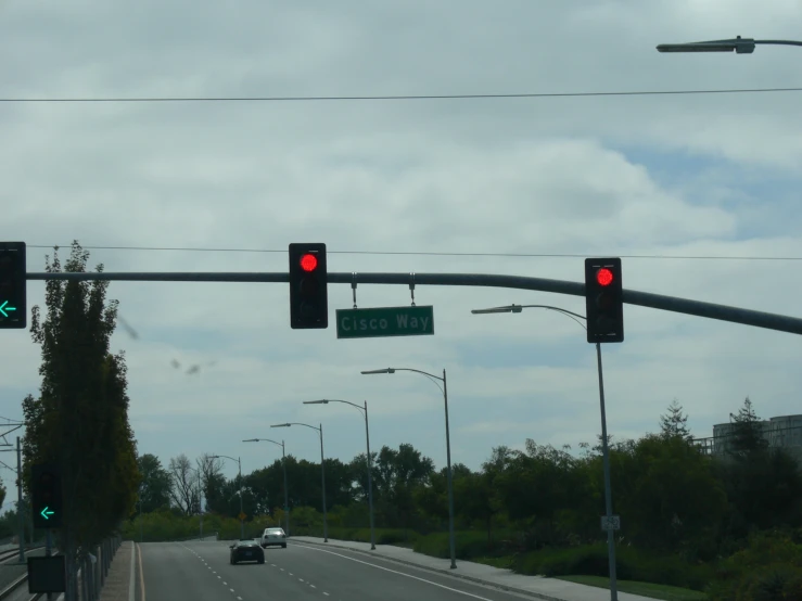 traffic lights on a city street over looking a highway