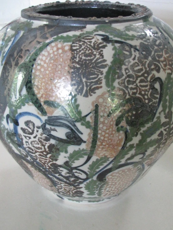 a large oriental vase with designs on it