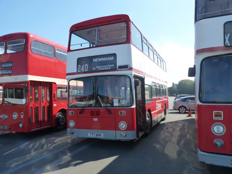 two double decked buses sitting side by side in traffic