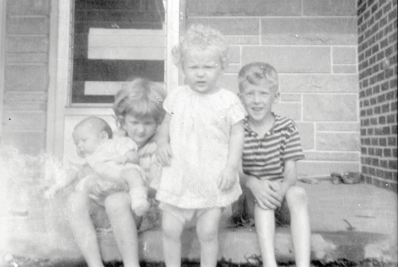 an old po shows three children posing for the camera