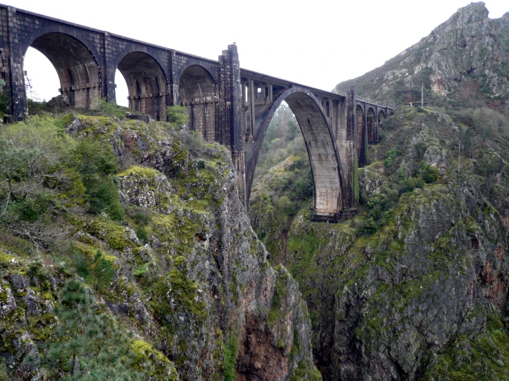 a bridge that is built over a mountain