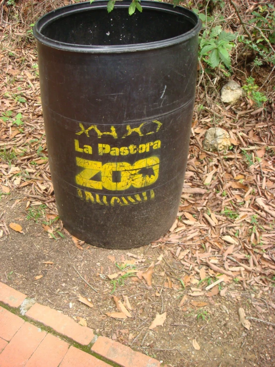 a large pot sitting in the grass by a curb