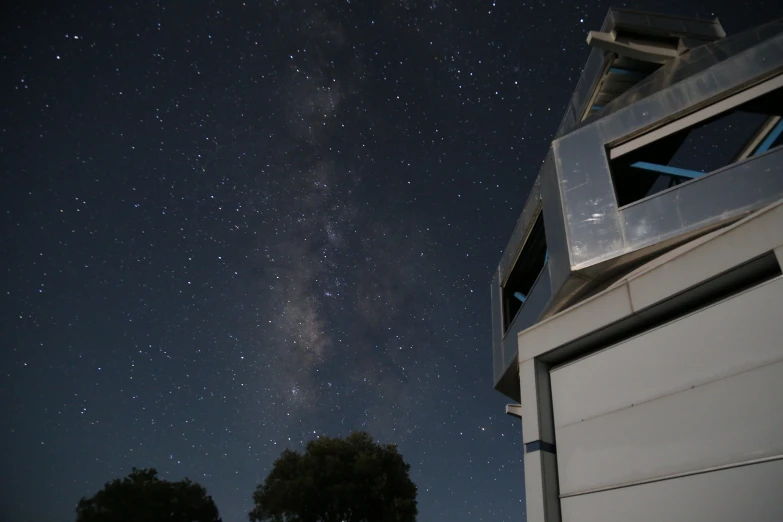 a tall structure with a sky full of stars