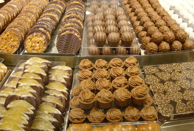 an assortment of different desserts and sweets displayed in trays