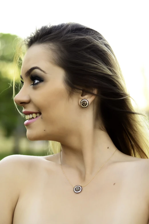 a beautiful young lady wearing two pieces of jewelry