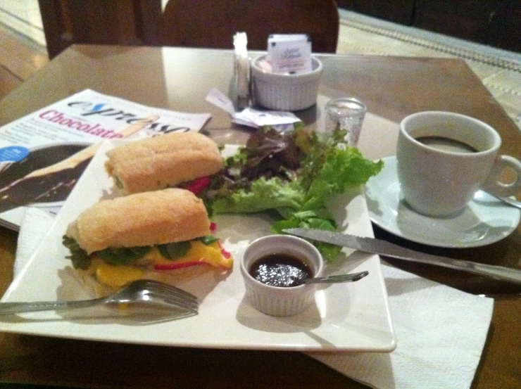 a meal with two sandwiches and salad, on a plate