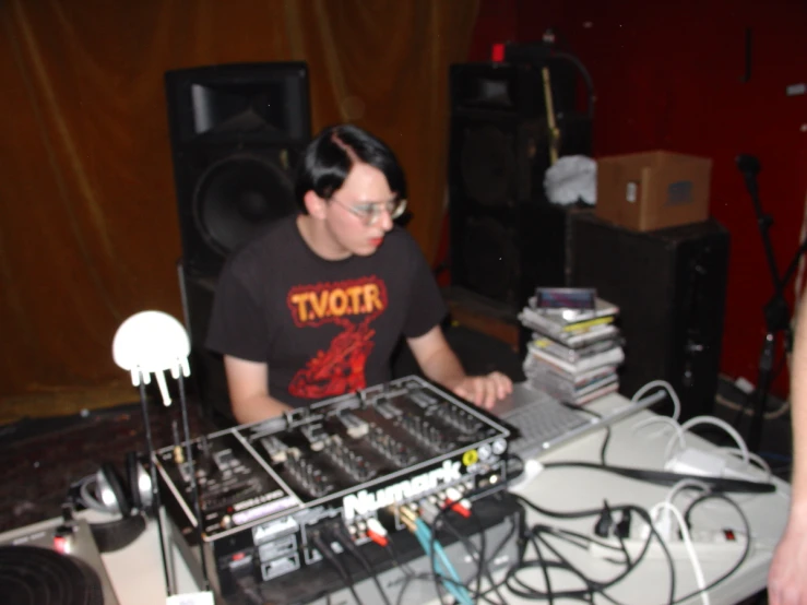 a man plays with his electronic music equipment